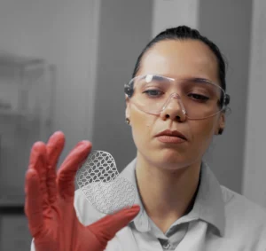 doctor holding a photochemically etched medical part