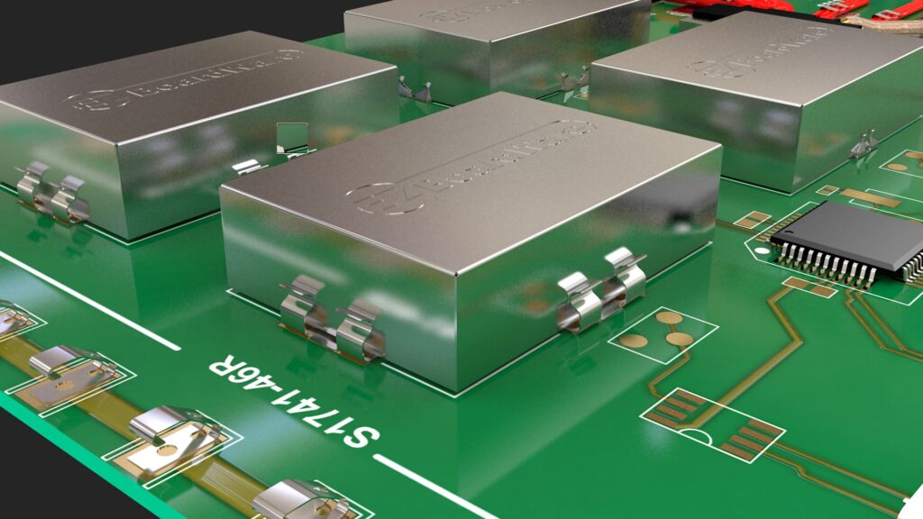 Metal EMI shielding covers mounted on a green printed circuit board.