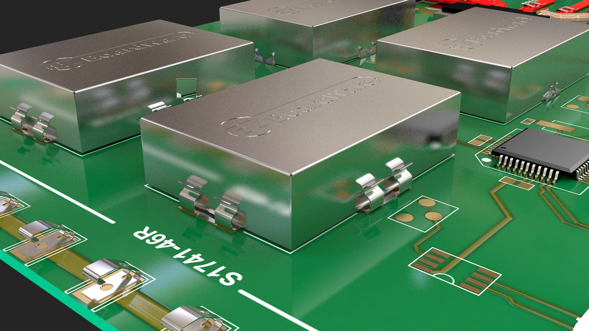 Metal EMI shielding covers mounted on a green printed circuit board.