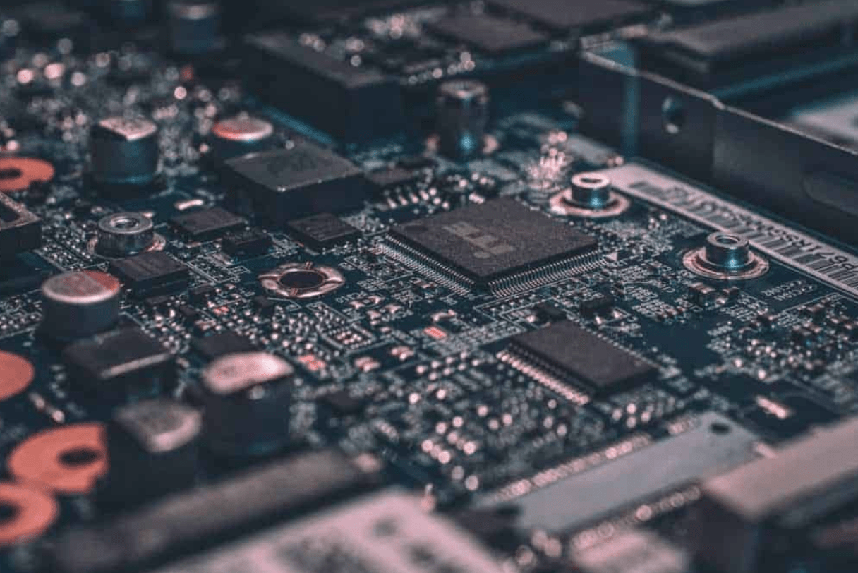 Close-up view of a computer motherboard with microchips, circuits, and electronic components used in modern hardware engineering.
